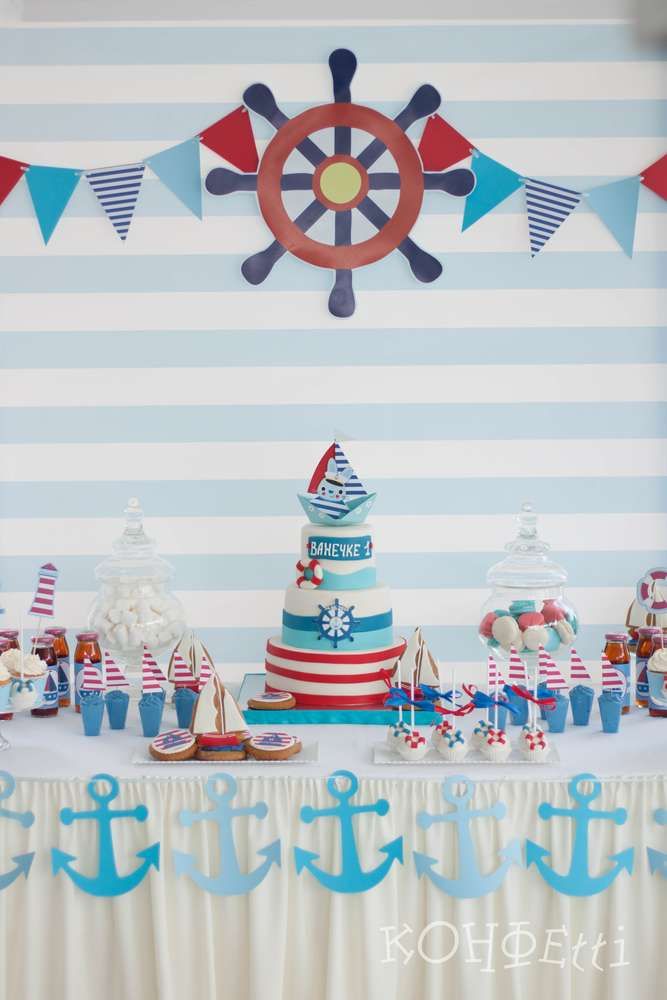 a table topped with a cake next to an anchor