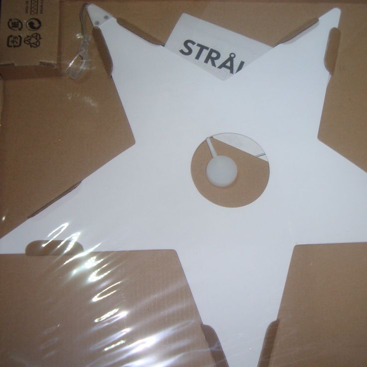 a cardboard star with the word stra on it and a white ball in the center