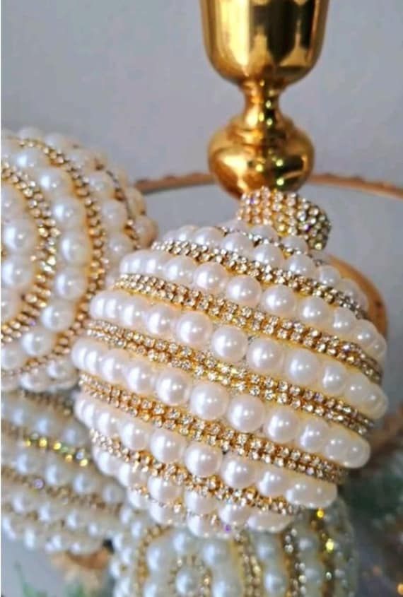 a chandelier with pearls hanging from it's sides