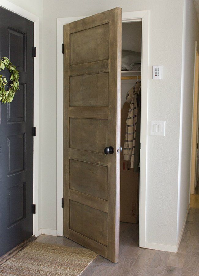 an open door leading into a bedroom with a rug on the floor and coat rack