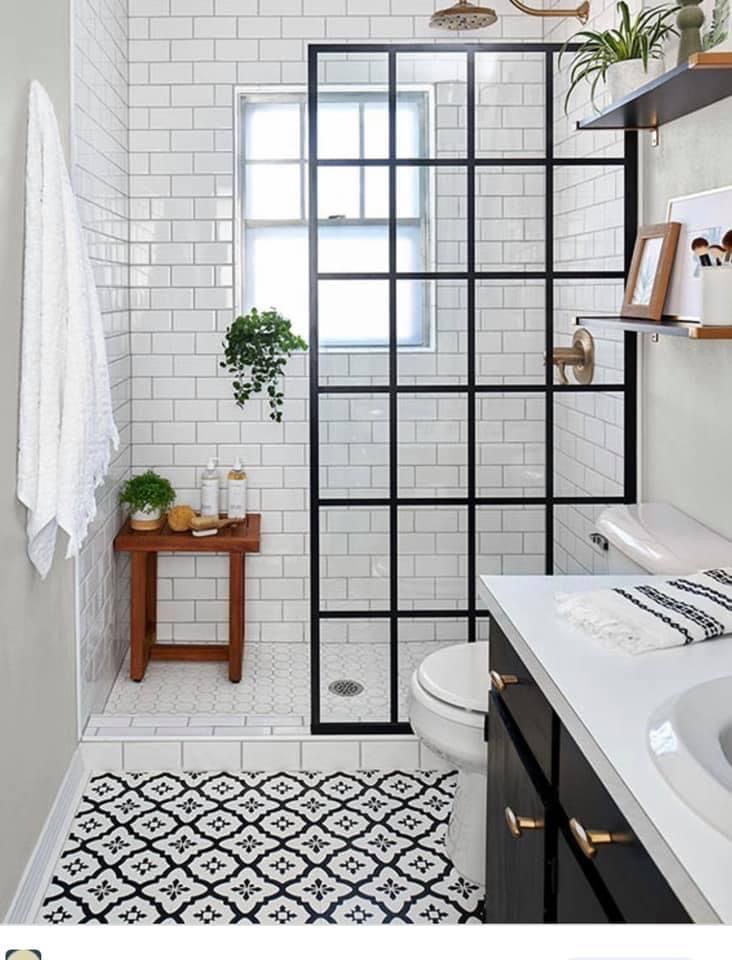 a bathroom with black and white tiles on the floor