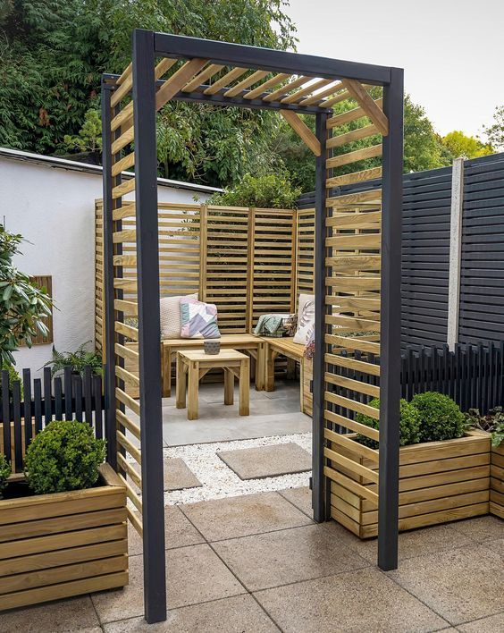 an outdoor garden with wooden planters and trelliss