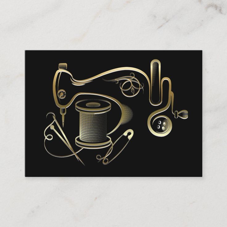 a black and gold business card with scissors, thread, spools and other items