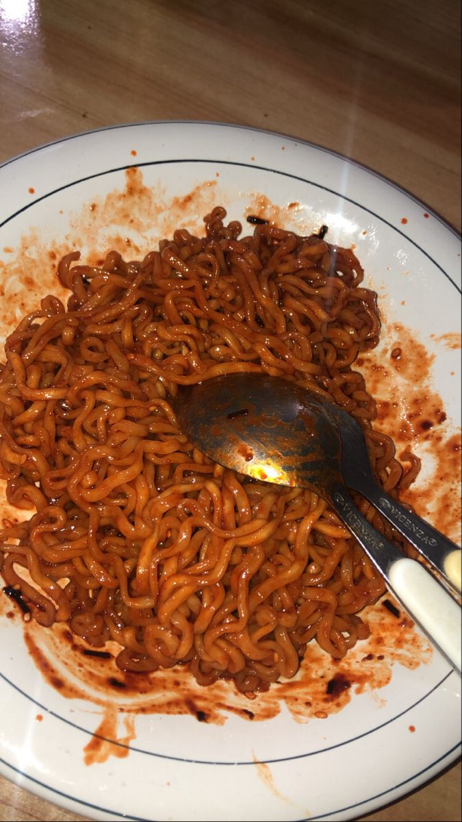 a white plate topped with noodles and sauce