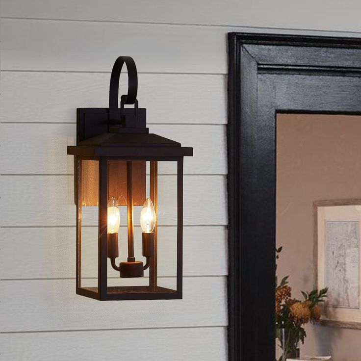 an outdoor light hanging on the side of a house