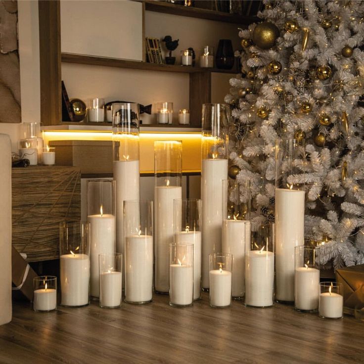 candles are arranged in front of a christmas tree