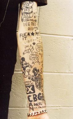 a person with tattoos on their arm and wrist