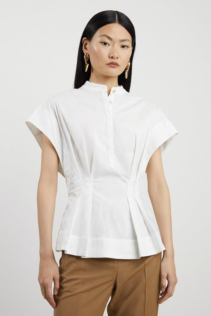 Feel Formal In Our Shirt, Made With High Quality Poplin Fabric, Featuring A Cinched Waist Which Flares At The Hips, And Wide Short Sleeves. This Piece Can Be Easily Paired With Anything From Tailored Trousers To Denim Jeans For Looks That Go From Office Days To Dinner Dates. Poplin Cap Sleeve Buttoned Pintuck Woven Shirt High Quality Poplin Fabric Flattering Cinched Silhouette Formal High Neckline Casual Short Sleeves Flared, Peplum Style Waist Women Shirt Designs Formal, Tailored Shirts For Women, Woven Tops For Women, Cotton Tops With Pintucks For Daywear, Cotton Workwear Tops With Pintucks, Summer Workwear Tops With Pintucks, Short Sleeve Tops With Pintucks For Daywear, Fitted Cotton Pleated Top, Casual Pintuck Short Sleeve Tops