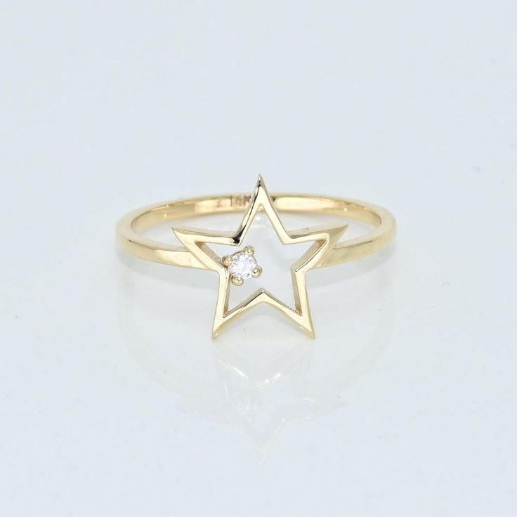 14k Solid Gold Dainty Star Ring, Real Gold Open Star Ring with premium grade D Color (colorless) VS/SI clarity moissanite.  💙 Our jewelry is handcrafted with love and great care at San Francisco Bay! All of our items are 14k stamped for authenticity. 💙 You will receive them exactly as pictured. We don't use any filters, all photos are authentic and unedited.   💙 Dimensions: Band thickness: 1.5 mm, Star: 12 mm. 💙 The ring material is 14k Solid gold, should not be confused with gold plating or filling. It won't tarnish or fade over time. 💙 We're offering the finest quality in solid gold jewelry. 💙 Quick shipping - Your order will be handcrafted and shipped in a few days. 🎁 They are delivered in a nice jewelry box, ready to be presented as a precious gift. 💎 Moissanite is the best alt Ring Unique Design, Handmade Fine Jewelry, Ruby Jewelry, Star Jewelry, Solid Gold Jewelry, Star Ring, Emerald Jewelry, Sapphire Jewelry, Ring Unique