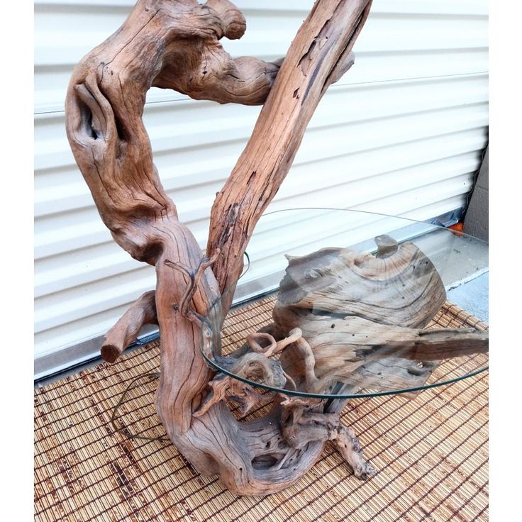 a glass table that has been made out of driftwood