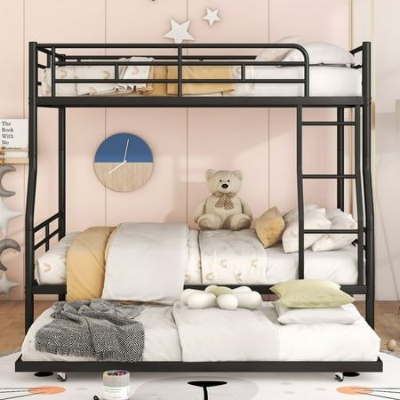 a bunk bed with a teddy bear sitting on top of it next to pillows and blankets