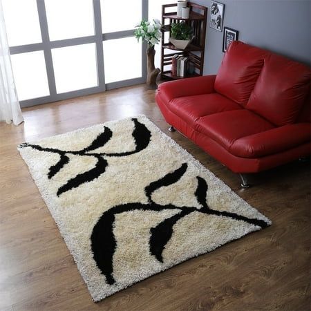 a living room with a red couch and white rug