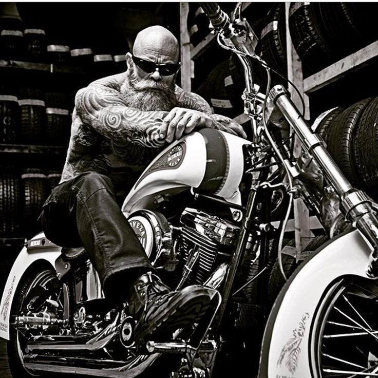 a black and white photo of a man sitting on a motorcycle with the caption harley davidson