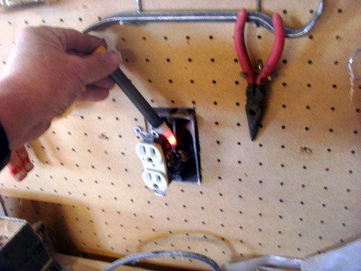 a person is working on some electrical equipment in a room with pegs and wires