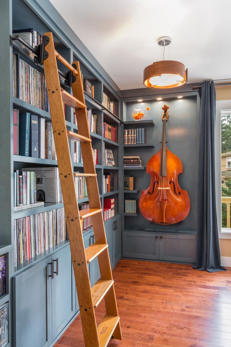 a room with bookshelves and a ladder in it