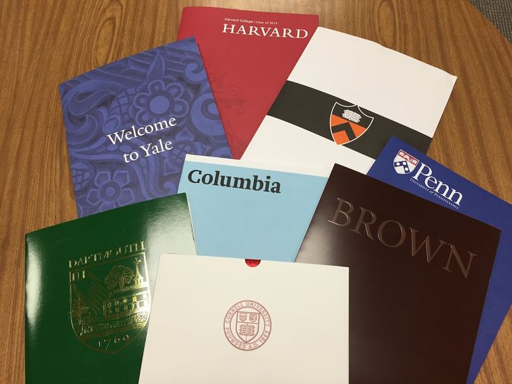 several different colored books on a table