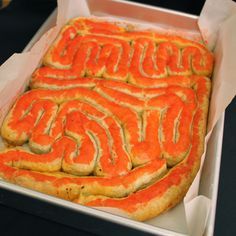 an orange cake in a box with writing on it