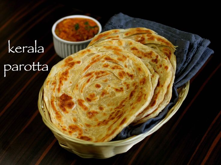 several flat breads sitting in a basket on a table