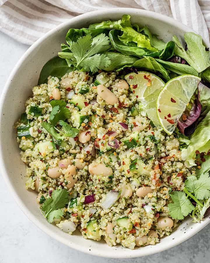 a white bowl filled with rice and vegetables