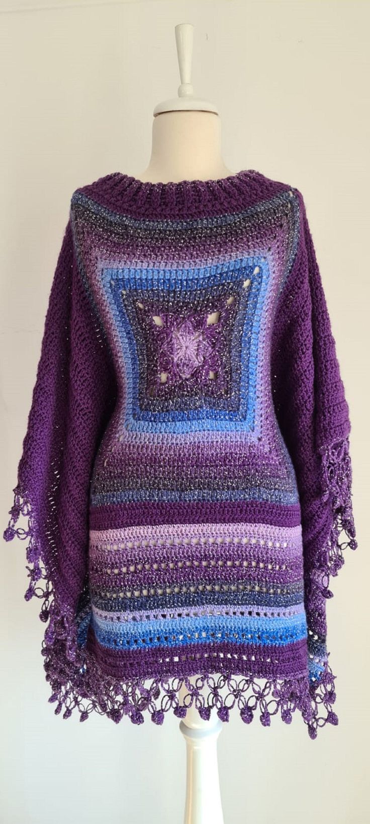 a crocheted sweater on a mannequin with a purple and blue pattern