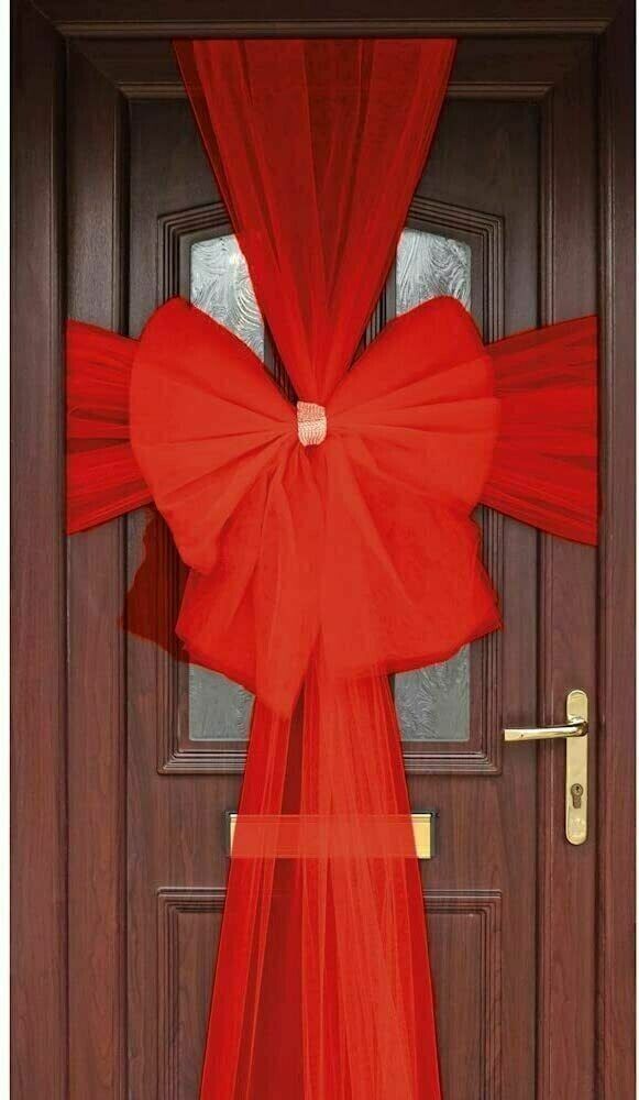 a red curtain is hanging over a door with a bow at the top and bottom