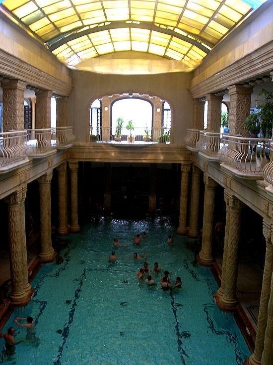 an indoor swimming pool with people in it