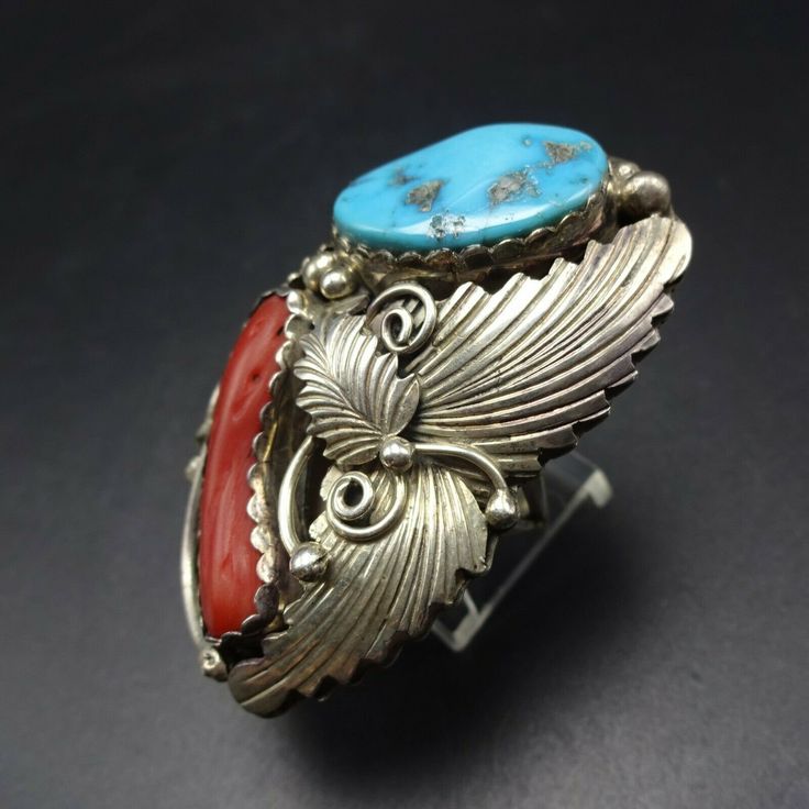 "VINTAGE NAVAJO RING DESCRIPTION: This spectacular ring features Sleeping Beauty turquoise and old red Mediterranean branch coral. The gemstones are secure in scalloped bezel, on a foundation of heavy gauge vintage sterling silver. Highly detailed applied leaves enhance the face of the ring. This impressive ring will be a treasured addition to your collection of fine vintage Native American jewelry. MEASUREMENTS: Ring face measures 2\" x 1 1/4\" Turquoise cabochon measures 20mm x 13mm RING SIZE: Vintage Red Gemstone Jewelry, Southwestern Style Red Ring Jewelry, Unique Red Multi-stone Turquoise Ring, Southwestern Multi-stone Red Ring, Southwestern Red Multi-stone Ring, Southwestern Style Red Turquoise Ring, Red Southwestern Multi-stone Rings, Retro Red Ring Jewelry, Vintage Red Rings