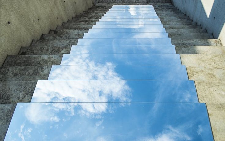 the sky is reflecting in the water on the ground, as if it were floating