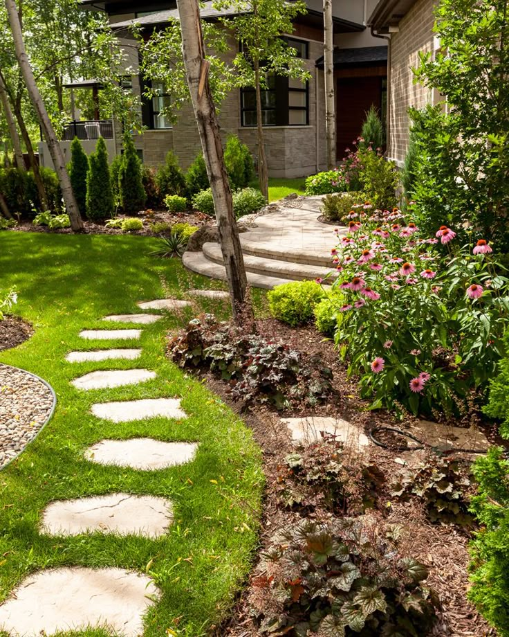 a garden with stepping stones in the grass