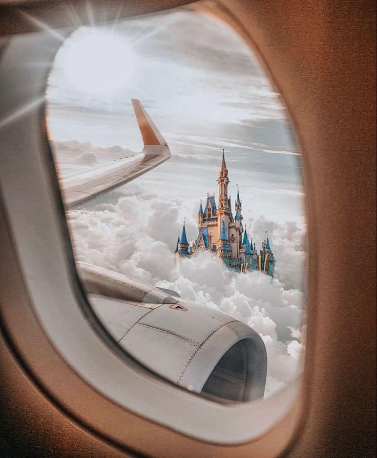 an airplane window with the view of a castle in the sky