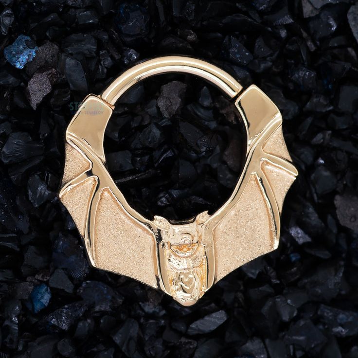 16 ga. 14K Yellow, White or Rose Gold Description & Features: Show off your spooky style and bring out your inner creature of the night with the "Lilith" hinge ring, this statement piece that features a bat with outstretched wings! Available in 5/16" and 3/8" diameter ★★★★★★★★★★★★★★★★★★★★★★ Brand: Body Vision Los Angeles - BVLA Collection: 41829 Material(s): 14K Gold Item Code: #1040 ( #36-1040 ) Commonly worn in: septum, daith Search Keywords: bodyvision, 16g, clicker, clickers, halloween, vamp Gothic Gold Rings For Halloween, Unique Gold Jewelry For Halloween, Gold Jewelry For Halloween, Unique Gold Halloween Jewelry, Body Vision Los Angeles, Hinged Ring, Gold Body Jewellery, Gold Bodies, Creatures Of The Night