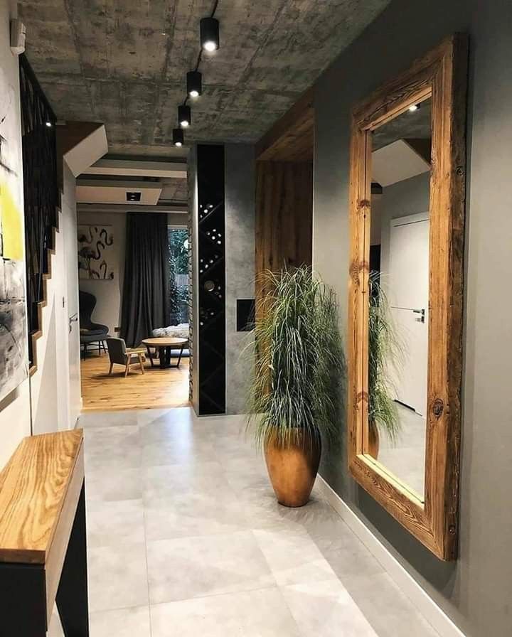 a large potted plant sitting in the middle of a hallway