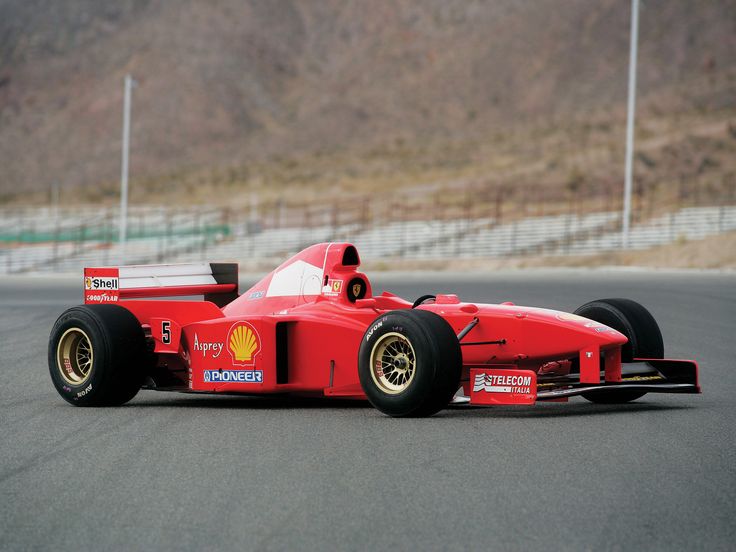 a red race car driving on a track