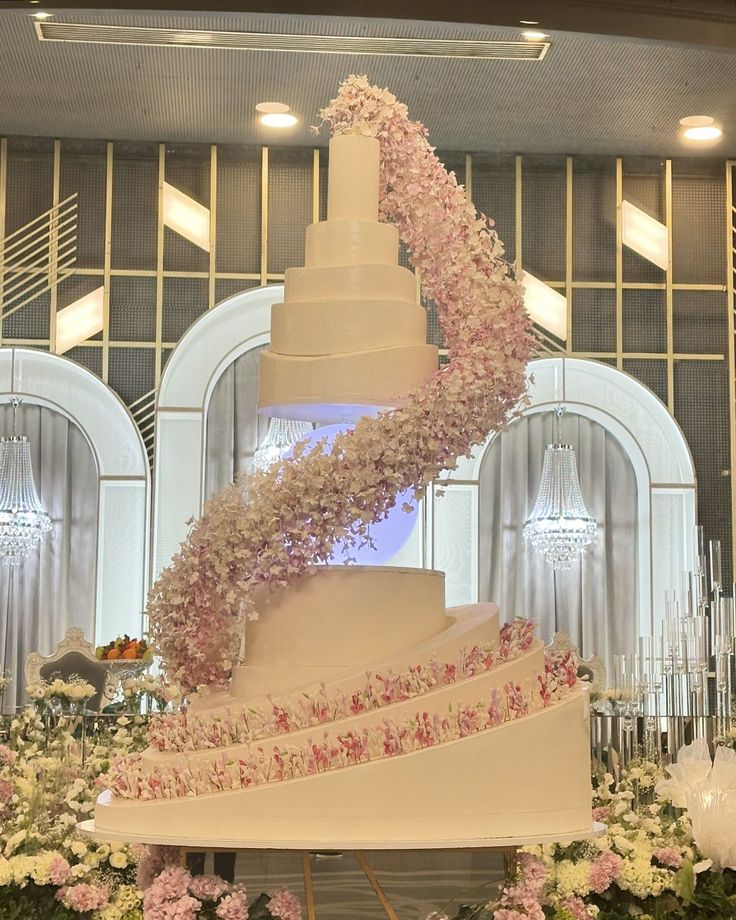 a wedding cake with pink and white flowers on it