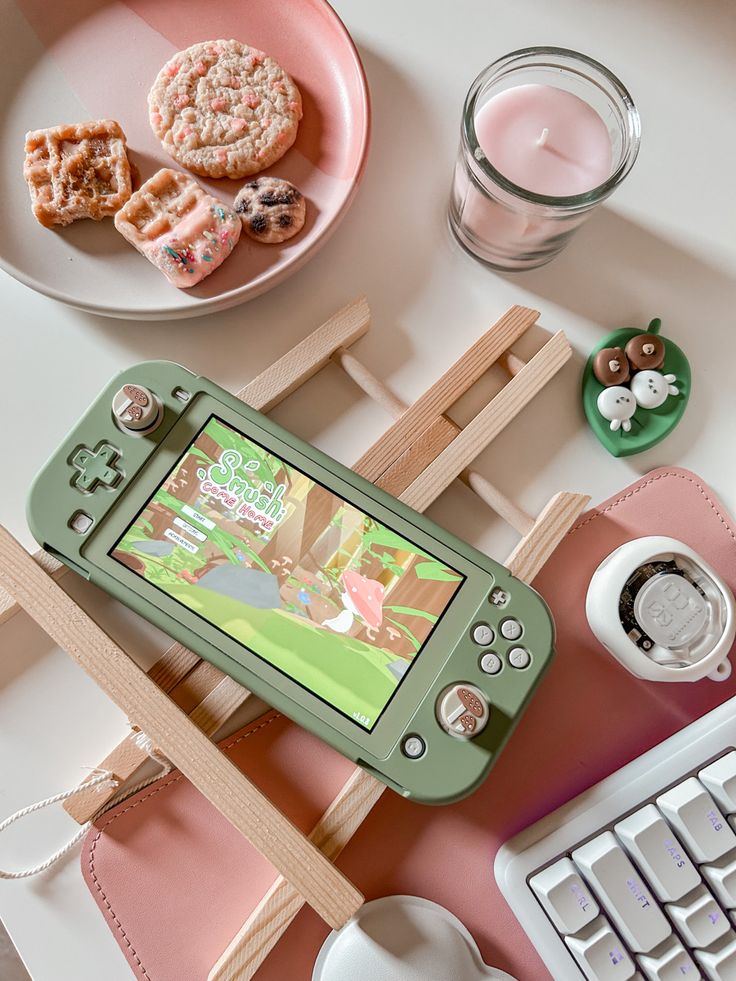 a nintendo wii game system sitting on top of a table next to a cup of coffee