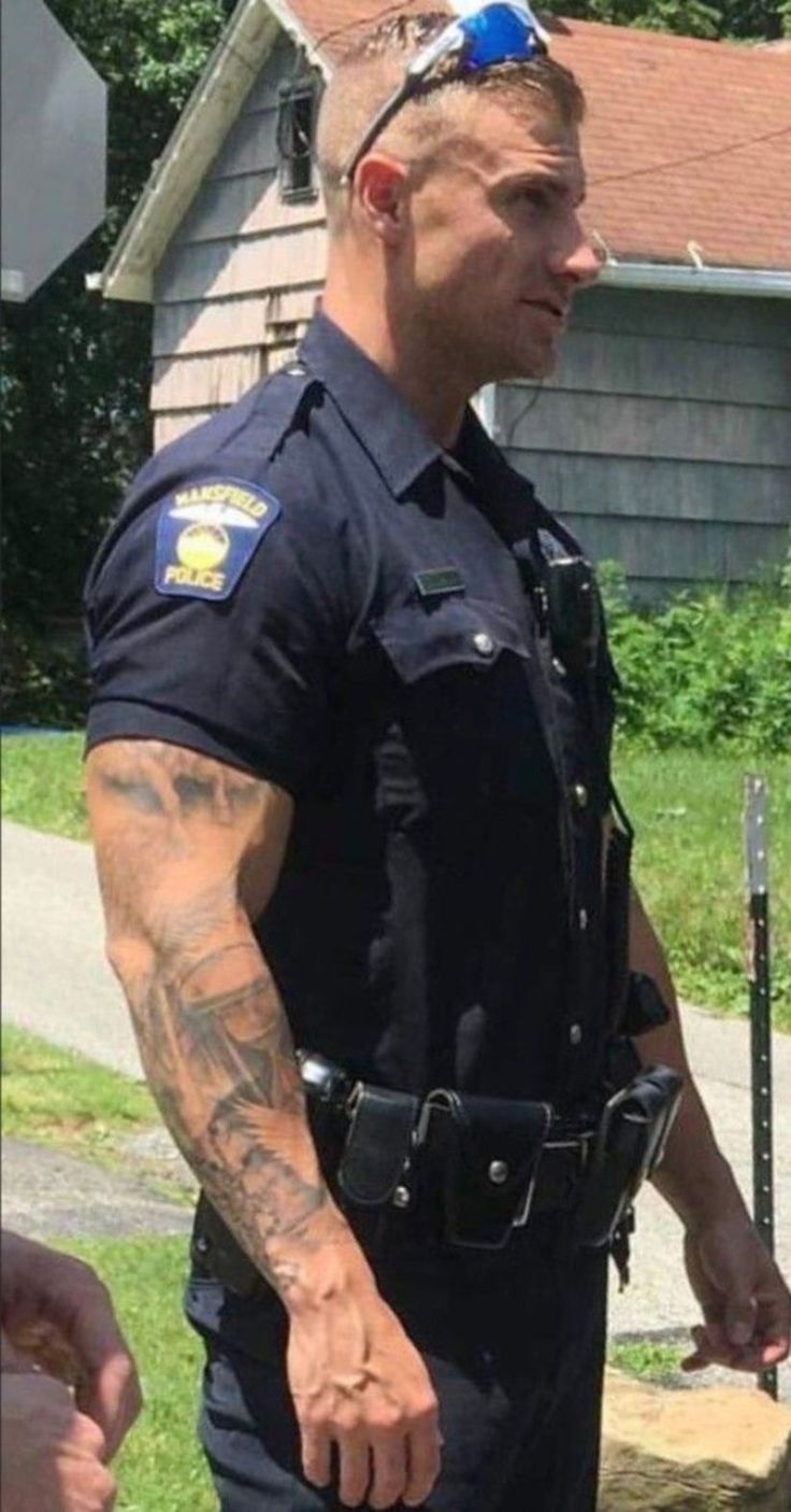 a police officer standing in front of a stop sign