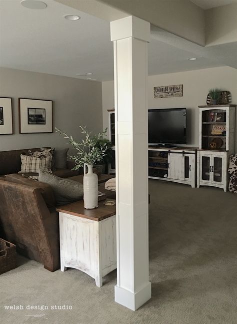 a living room filled with furniture and a flat screen tv on top of a wooden stand