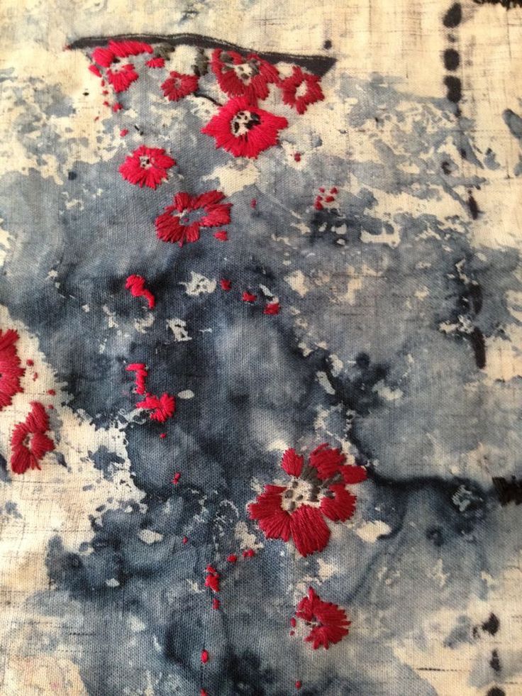 an abstract painting with red flowers on grey and black paint splattered over it