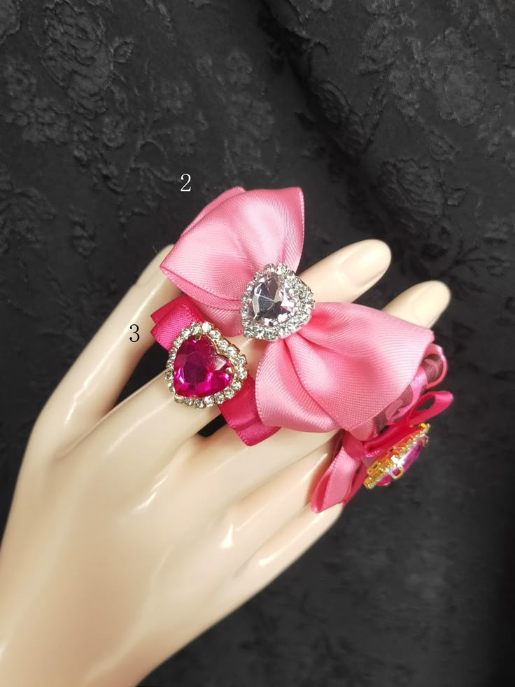 Embrace the charm of delicate elegance with our bowknot heart rhinestone ring. This enchanting piece showcases a beautifully crafted bowknot design, accentuated with sparkling heart-shaped rhinestones that catch the light with every movement. Perfect for adding a touch of whimsy to any outfit, this ring is a must-have accessory for those who adore kawaii and lolita fashion.  Please note, the price is for one ring only. Coquette Jewelry, Heart Rhinestone, Gyaru Fashion, Bow Ring, Rhinestone Ring, Pretty Stuff, Blue Rhinestones, One Ring, Pretty Jewellery