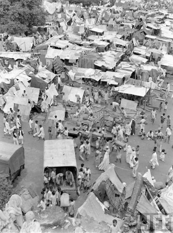 an old black and white photo of many tents