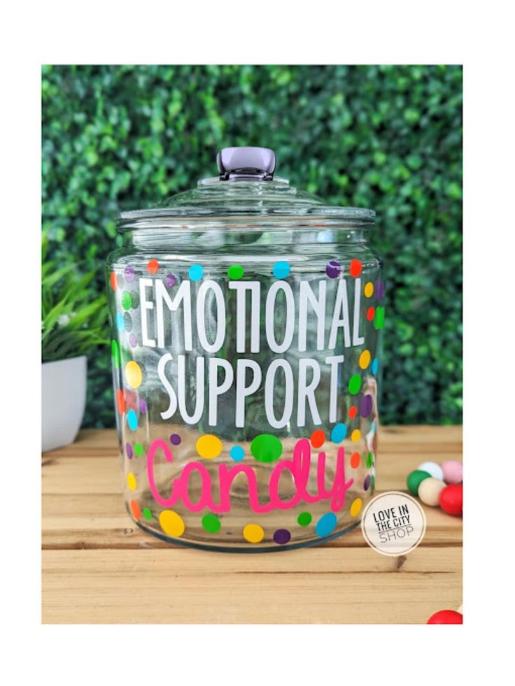 a glass jar filled with colorful confetti and the words'emotion support '