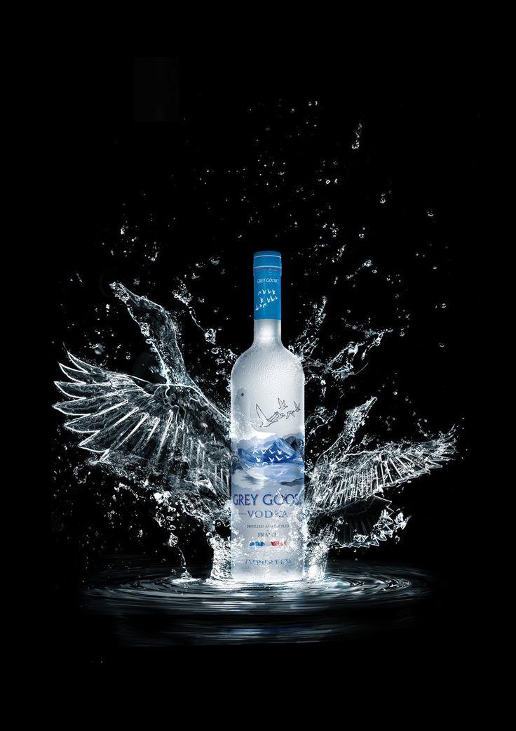 a bottle of vodka with water splashing out of it's top and wings on the side