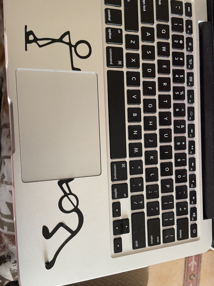 an open laptop computer sitting on top of a table next to a keyboard and mouse