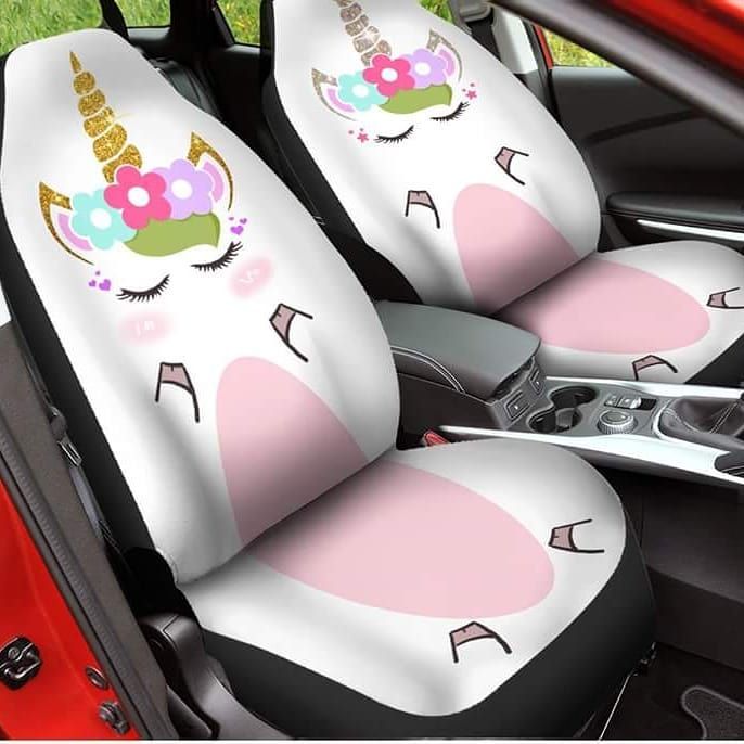 the seat covers in the car are decorated with unicorn ears and flowers, while the steering wheel is down