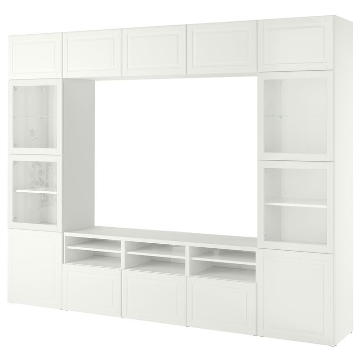 a large white entertainment center with shelves and cupboards on each side, in front of a white background