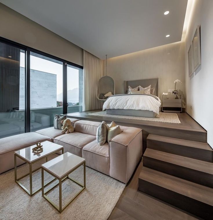 a living room filled with furniture next to a large glass door leading to a balcony