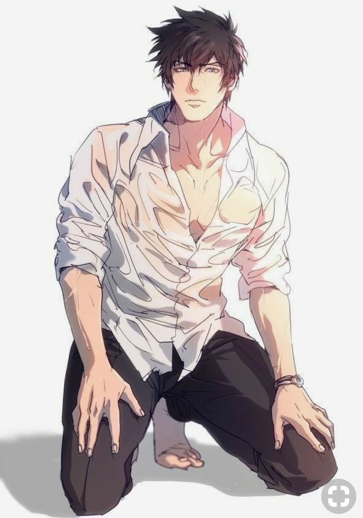 a man sitting on the ground with his hands in his pockets and wearing a white shirt