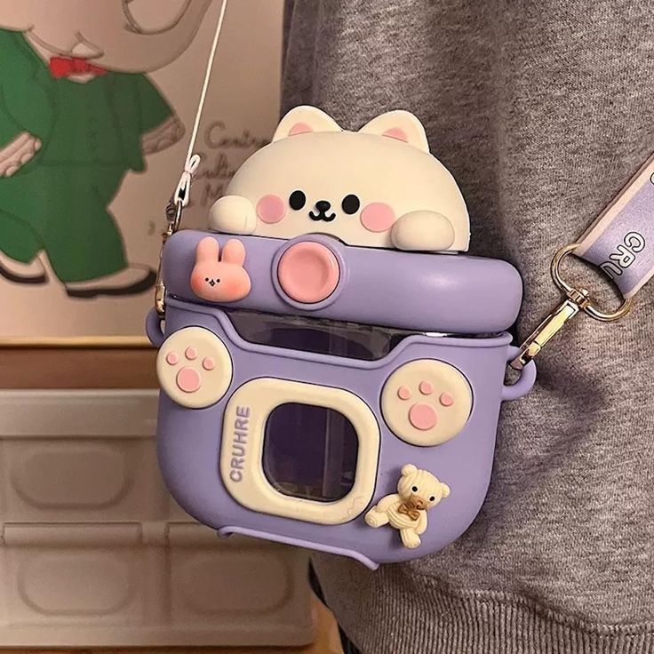 a person holding a purple and white cell phone case with a bear on the front