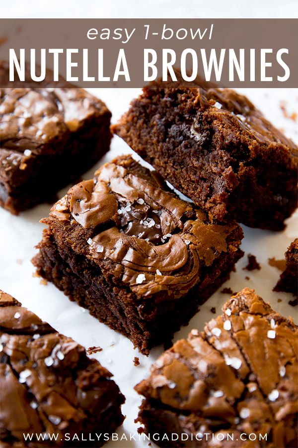 brownies with chocolate frosting and sea salt sprinkled on top are sitting on a white surface