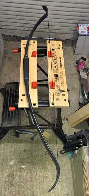 a couple of pieces of wood sitting on top of a floor next to some tools